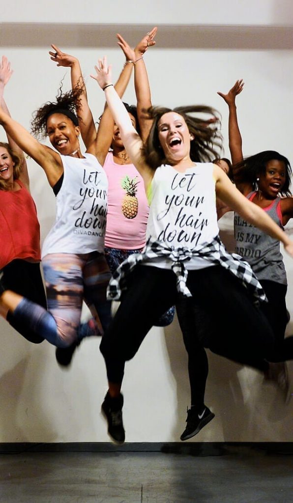 women jumping and smiling