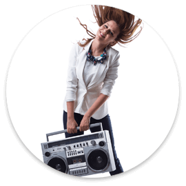 woman holding boombox in front of plain white wall