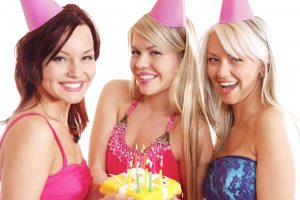 three women in party hats