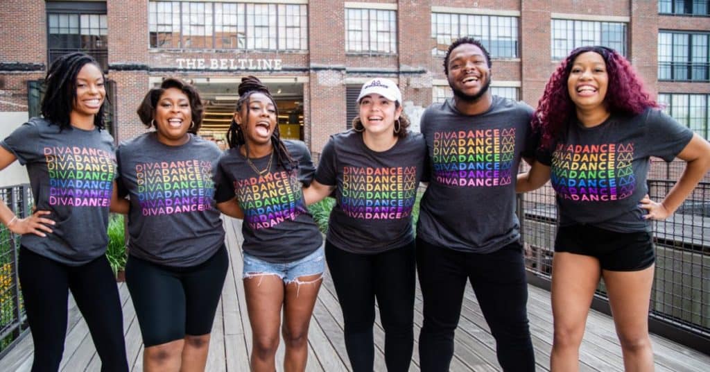 Six Diverse People Arm in Arm Smiling Wearing Pride DivaDance T-shirts