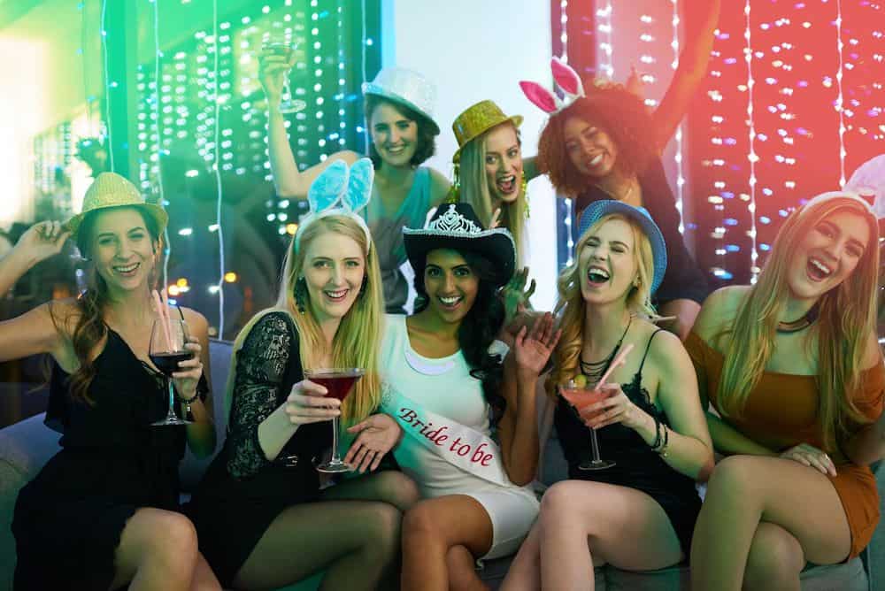 Girls in cute dresses and hats celebrating a bachelorette party