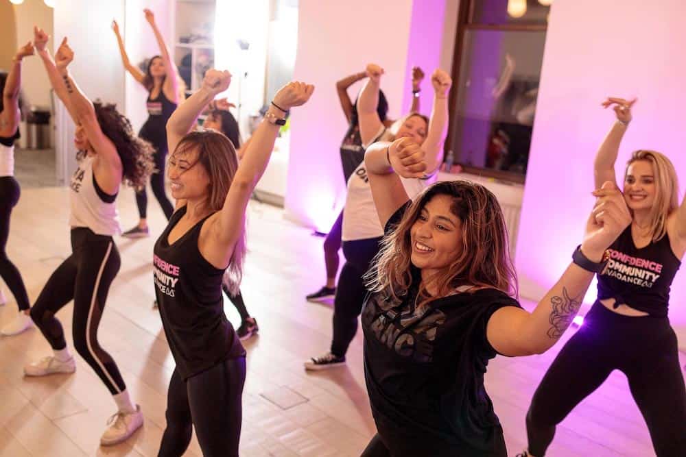 A group of women dancing in a room.