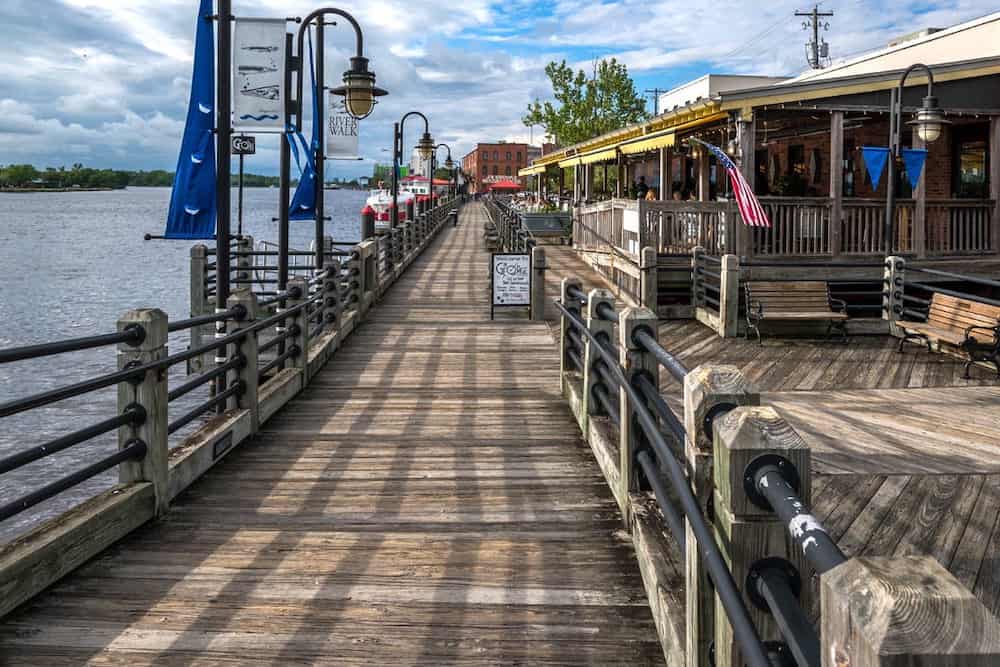 A wooden pier leading to a restaurant and bar.