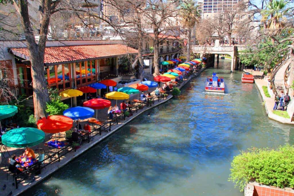 Colorful umbrellas on a river.