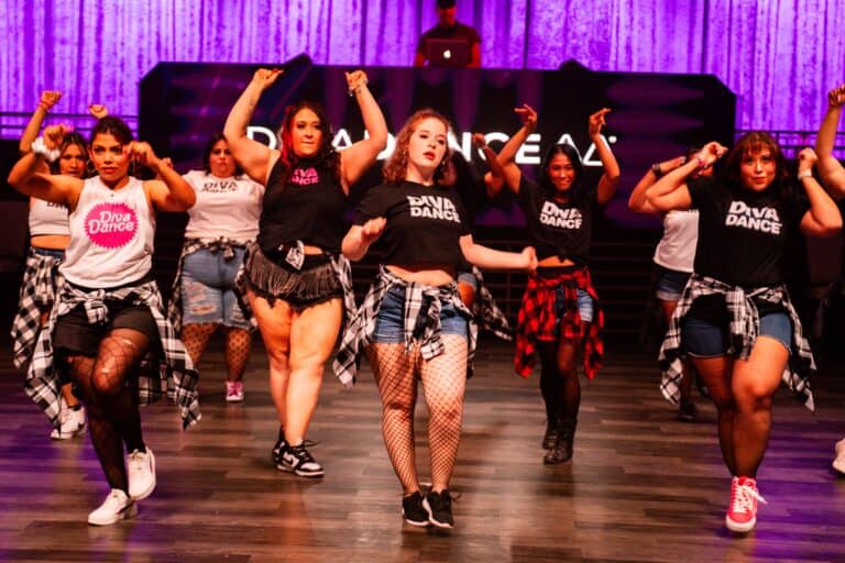 One of the best bachelorette party ideas in Las Vegas? DivaDance! A group of dancers perform with flannels around their waists.