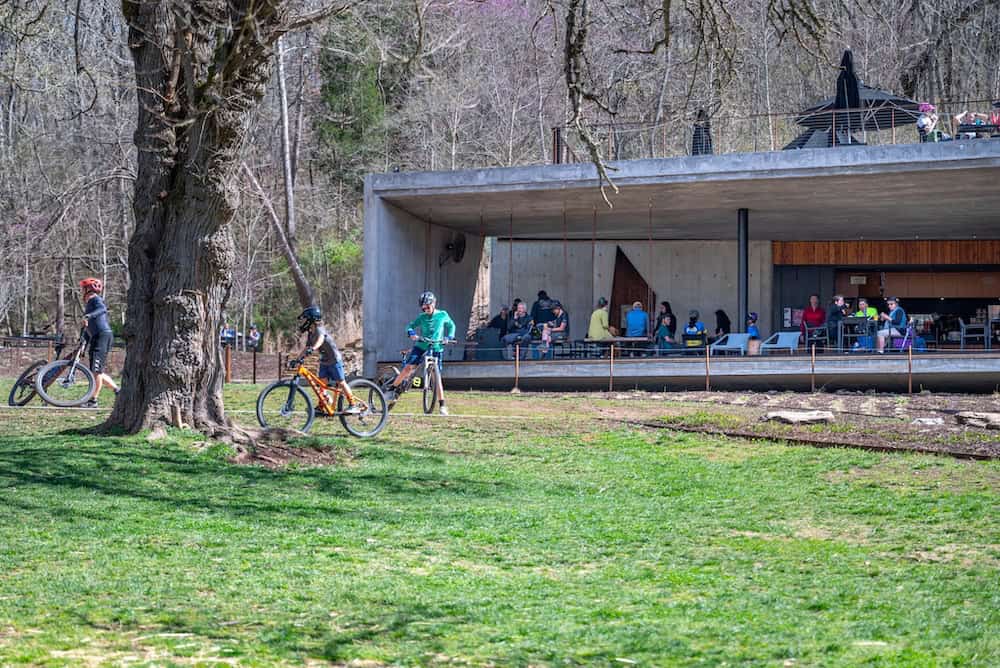 Cyclists and pedestrians enjoy a sunny day at the Color Mountain Bike Preserve, one of the more fun and outdoorsy bachelorette party ideas in Northwest Arkansas