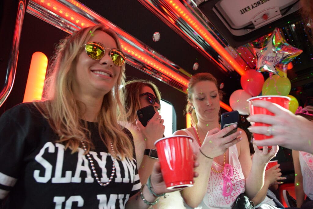 friends celebrating a girls night out in mesa on a party bus